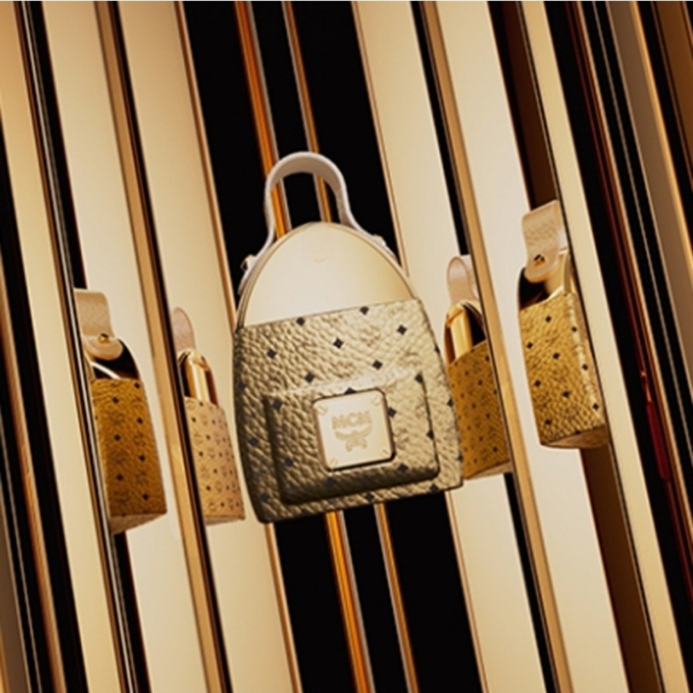 MCM Gold and Tan Mini Backpack perfume